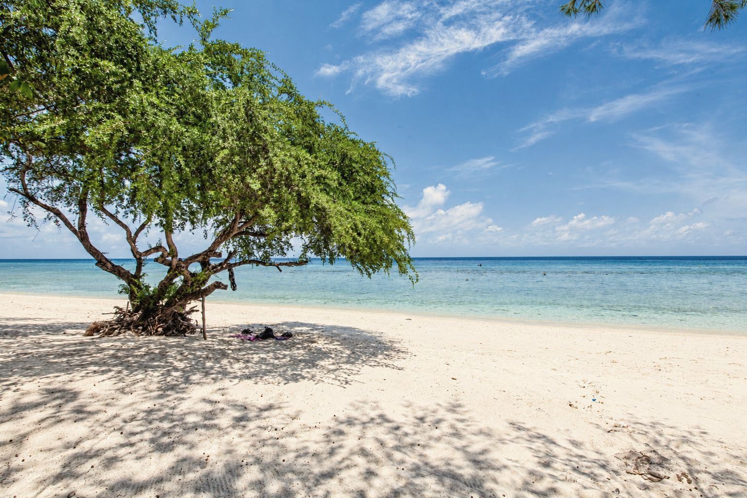 Sun loungers and umbrellas on the north beach of Gili Trawangan